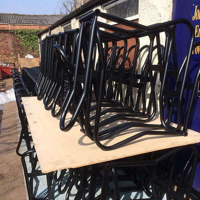 Black powder coated bike racks drying outside