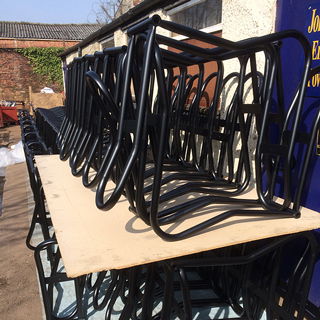 Black powder coated bike racks drying outside