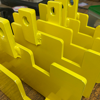 New yellow powder coated metal work