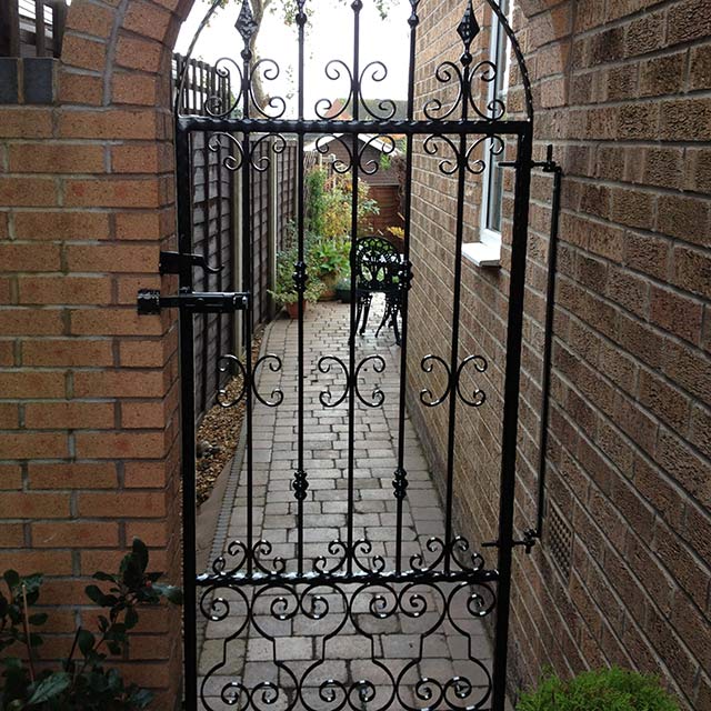Black powder coated entry gate to the back garden