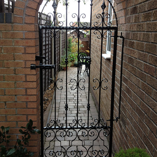 Black powder coated entry gate to the back garden